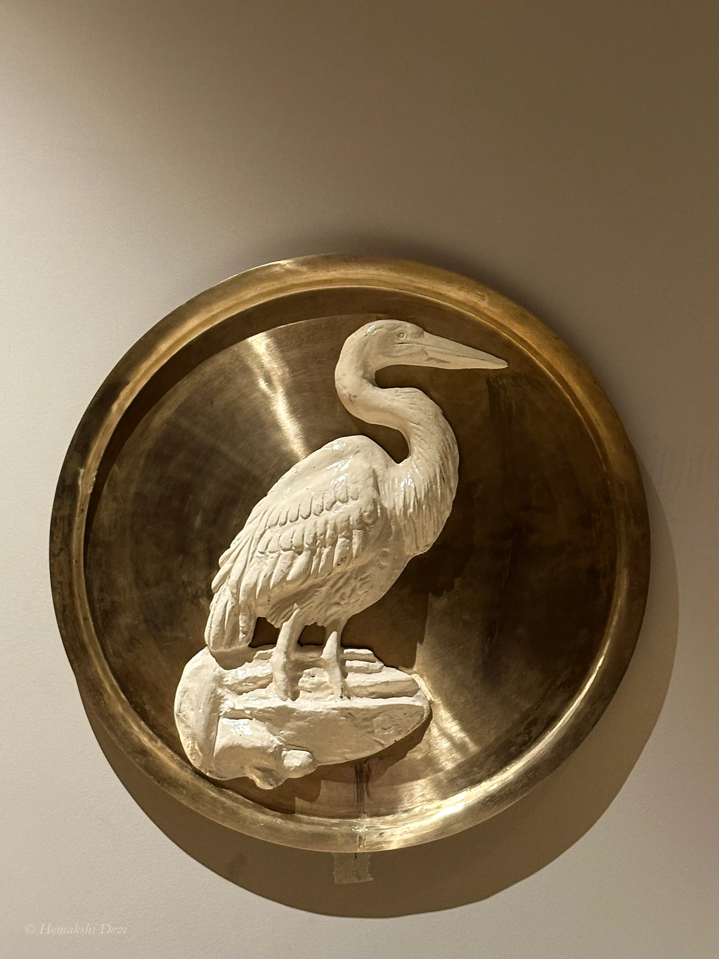 Detail of a bell-metal medallion with a Kaziranga bird relief